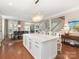 Open-concept kitchen featuring a large island, pendant lighting, and hardwood floors, flowing into a dining area at 9636 Cotton Stand Rd, Charlotte, NC 28277