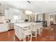 Open kitchen with a large island, white cabinets, and modern appliances at 9636 Cotton Stand Rd, Charlotte, NC 28277