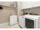 Efficient laundry room featuring modern washer, dryer, sink, and ample storage at 9636 Cotton Stand Rd, Charlotte, NC 28277