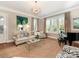 Bright living room with comfortable seating, large windows, piano, and stylish decor at 9636 Cotton Stand Rd, Charlotte, NC 28277