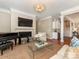 Spacious living room featuring a fireplace, piano, bar area, and comfortable seating at 9636 Cotton Stand Rd, Charlotte, NC 28277