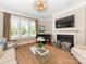 Cozy living room featuring a fireplace, large windows, piano, and elegant decor at 9636 Cotton Stand Rd, Charlotte, NC 28277