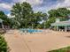 Community pool area with lounge chairs, a pavilion, and lush green trees at 9636 Cotton Stand Rd, Charlotte, NC 28277
