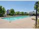 Community pool with lounge chairs, clubhouse, and well-manicured landscaping at 9636 Cotton Stand Rd, Charlotte, NC 28277