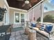 Enjoy outdoor living on this screened porch with plush seating and ceiling fan at 9636 Cotton Stand Rd, Charlotte, NC 28277