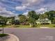 Charming street view featuring colorful homes with palm trees and well-maintained landscaping at 9636 Cotton Stand Rd, Charlotte, NC 28277