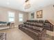 Home theater with plush seating, a decorative light fixture, and framed art at 9636 Cotton Stand Rd, Charlotte, NC 28277