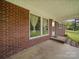 Covered back porch with brick and concrete patio, perfect for outdoor relaxation at 101 Stoneybrook Dr, York, SC 29745