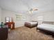 Cozy bedroom featuring carpet, ceiling fan, and natural light streaming through windows at 101 Stoneybrook Dr, York, SC 29745