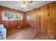 Bedroom featuring wood paneled walls, hardwood floors, and a ceiling fan at 101 Stoneybrook Dr, York, SC 29745