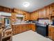 Cozy kitchen showcasing vintage wood cabinetry, marble countertops, and black appliances at 101 Stoneybrook Dr, York, SC 29745