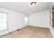 Bright bedroom with neutral walls, windows, and tan flooring at 1043 Sid Davis Rd, Chester, SC 29706