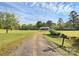 Exterior daytime shot of the home featuring a long driveway and blue siding at 1043 Sid Davis Rd, Chester, SC 29706