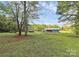 Exterior daytime shot of the home featuring a lush green lawn and shade trees at 1043 Sid Davis Rd, Chester, SC 29706