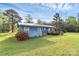 A blue home featuring a metal roof with a landscaped yard and a charming wooden deck at 1043 Sid Davis Rd, Chester, SC 29706