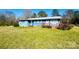 Charming blue home with a metal roof and a cozy red front porch at 1043 Sid Davis Rd, Chester, SC 29706