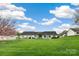 Home exterior featuring a large backyard with well-kept lawn at 113 Hidden Creek Dr, Salisbury, NC 28147