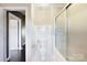 Modern bathroom featuring tiled shower, glass doors, and neutral color palette at 113 Hidden Creek Dr, Salisbury, NC 28147