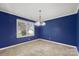 Dining room with blue walls, tile floors, and a modern chandelier perfect for entertaining at 113 Hidden Creek Dr, Salisbury, NC 28147