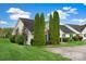 Well-maintained house exterior featuring a green lawn, trees, and a paved driveway at 113 Hidden Creek Dr, Salisbury, NC 28147