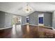 Open-concept living room featuring hardwood floors, a fan, and neutral wall color at 113 Hidden Creek Dr, Salisbury, NC 28147