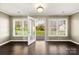 Sunroom with lots of natural light, featuring hardwood floors and views of the backyard at 113 Hidden Creek Dr, Salisbury, NC 28147