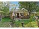 Brick home with a covered porch, mature landscaping, and a classic American flag, showcasing cozy charm at 115 E 11Th St, Salisbury, NC 28144