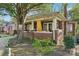 Covered front porch with red-tiled flooring, offering a charming space for outdoor relaxation and decor at 115 E 11Th St, Salisbury, NC 28144
