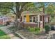 Covered porch showcases red brick construction and vintage charm, a cozy spot for outdoor enjoyment at 115 E 11Th St, Salisbury, NC 28144