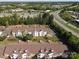 An aerial view of the condo complex shows parking and landscaping near a highway at 11839 Ridgeway Park Dr, Charlotte, NC 28277