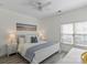 Well-lit bedroom featuring hardwood floors, a queen-sized bed, and a large window at 11839 Ridgeway Park Dr, Charlotte, NC 28277