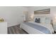 Bright bedroom featuring hardwood floors, a queen-sized bed, and neutral decor at 11839 Ridgeway Park Dr, Charlotte, NC 28277