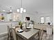 Open dining area with a modern table set, leading to a bright living space and kitchen at 11839 Ridgeway Park Dr, Charlotte, NC 28277