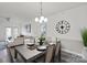 Elegant dining area with a modern table set, open to a bright living space and kitchen at 11839 Ridgeway Park Dr, Charlotte, NC 28277