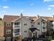 Condo complex featuring brick and vinyl siding with balconies against a bright blue sky at 11839 Ridgeway Park Dr, Charlotte, NC 28277