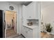 Well-lit kitchen with white cabinetry, modern appliances, and convenient access to laundry area at 11839 Ridgeway Park Dr, Charlotte, NC 28277
