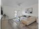 Bright living room featuring wood floors, a comfortable sofa, and a sliding glass door at 11839 Ridgeway Park Dr, Charlotte, NC 28277