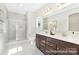 Modern bathroom with double vanity, shower, and neutral colors at 1303 Links Crossing Dr # 219, Monroe, NC 28112