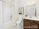 Modern bathroom with a shower-tub combo, vanity with storage, and decorative wall art at 1303 Links Crossing Dr # 219, Monroe, NC 28112