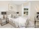 Well-lit bedroom with large window, bedside tables, and contemporary decor elements at 1303 Links Crossing Dr # 219, Monroe, NC 28112