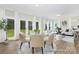 Bright dining room with large windows, glass table, and neutral decor at 1303 Links Crossing Dr # 219, Monroe, NC 28112