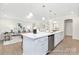 Spacious kitchen island with stainless steel dishwasher opens to a cozy living area at 1303 Links Crossing Dr # 219, Monroe, NC 28112