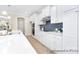 Bright kitchen with white cabinetry, stainless steel appliances, and a stylish tile backsplash at 1303 Links Crossing Dr # 219, Monroe, NC 28112