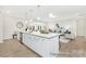 Modern kitchen island with stainless steel features and an open design to the living space at 1303 Links Crossing Dr # 219, Monroe, NC 28112