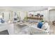 Open-concept living space featuring modern decor, breakfast bar, and seamless flow to kitchen at 1303 Links Crossing Dr # 219, Monroe, NC 28112