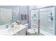 Bathroom features a single sink vanity, toilet, and enclosed shower with sleek glass doors and white shelving at 134 Falling Up Ln, Salisbury, NC 28147