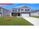 Charming two-story home with stone accents, a two-car garage, and a well-manicured front lawn at 134 Falling Up Ln, Salisbury, NC 28147
