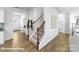 Hallway with carpeted staircase, hardwood floors, and views into other rooms at 134 Falling Up Ln, Salisbury, NC 28147