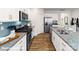 Bright kitchen showcases granite counters, stainless steel appliances, white cabinets, tile backsplash, and a large island with a sink at 134 Falling Up Ln, Salisbury, NC 28147