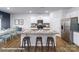Stylish kitchen featuring white cabinets, a granite island with stools, and stainless steel appliances at 134 Falling Up Ln, Salisbury, NC 28147